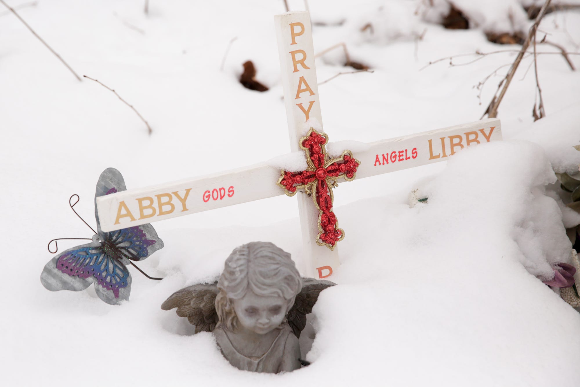 A cross for Abby Williams and Libby German sits in the snow along the Monon High Bridge Trail, Wednesday, Feb. 10, 2021 in Delphi.