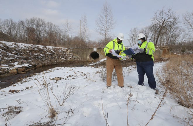 G. Stephens Inc. Senior Construction Manager John Harris, left, and Project Manager Leah Gillig at the Camp Brook River Restoration Project at the Evans Avenue Project site on Thursday, Feb. 11, 2021 in Akron, Ohio. [Phil Masturzo/ Beacon Journal]
