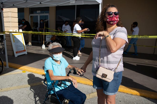 Immokalee resident Agnes Barrera, left, waits with her daughter Mary Montes to receive her second vaccine during a Healthcare Network vaccination clinic, Tuesday, Feb. 9, 2021, in Immokalee.