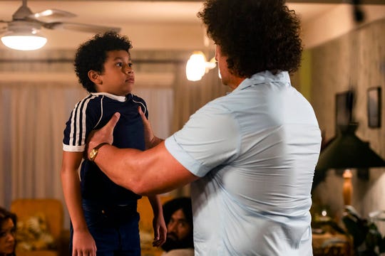 Andre the Giant (Matthew Willig) lifts a young Dwayne Johnson (Adrian Groulx) in the debut episode of "Young Rock."
