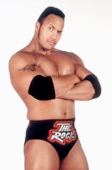 Dwayne Johnson flexes the People's Eyebrow as his wrestling persona "The Rock" in 1999.