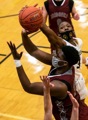 Ambridge's Enire Bowens tries to get a shot off as Quaker Valley's Adou Their blocks during their game Thursday at Quaker Valley High School in Leetsdale.