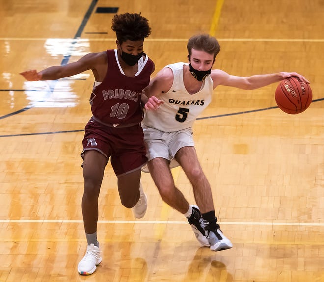 Ambridge's Nino Rideout gives close coverage to Quaker Valley's Jack Gardinier during their game Thursday at Quaker Valley High School in Leetsdale.