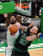 Boston Celtics center Daniel Theis (27) defends against Detroit Pistons forward Saddiq Bey (41) in the fourth quarter Feb. 12, 2021, at TD Garden.
