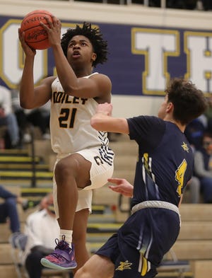 Copley's Khoi Thurmon, left, looks to the basket to score against Tallmadge's Nicholas Lambacher during the first half of a basketball game, Saturday, Feb. 13, 2021, in Copley, Ohio. [Jeff Lange/Beacon Journal]