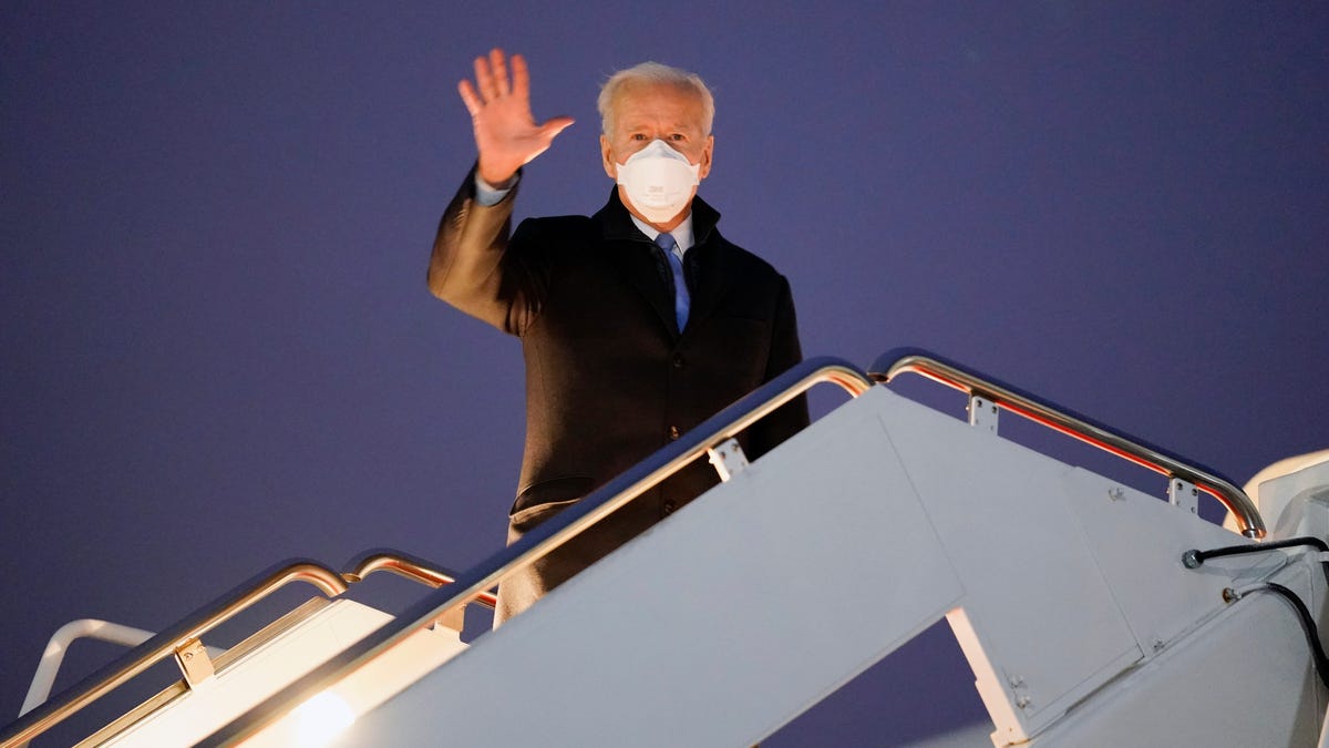 President Joe Biden waves before boarding Air Force One for a trip to Camp David, Friday, Feb. 12, 2021, in Andrews Air Force Base, Md.
