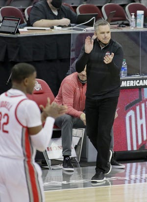 Ohio State Buckeyes head coach Chris Holtmann claps on the sideline during the second half of Wednesday's NCAA Division I basketball game against the Northwestern Wildcats at Value City Arena in Columbus, Oh., on Wednesday, January 13, 2021. Ohio State won the game 81-71.