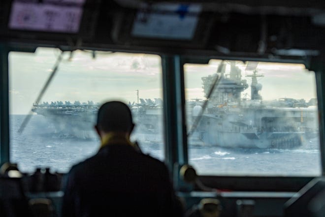 Lt. j. g. Jonathan Tang monitors the distance to the aircraft carrier USS Nimitz from the guided-missile destroyer USS Sterett during dual carrier operations on Feb. 9. After several delays, the Nimitz has finally been ordered back to its homeport in Bremerton.