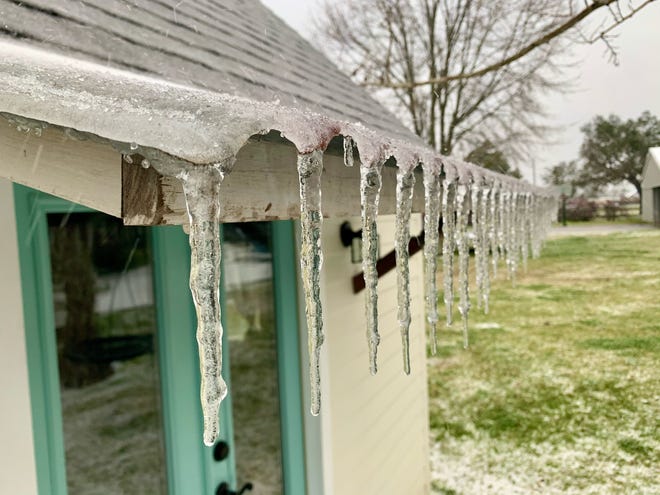 Ice hangs from a roof as a hard freeze hits Acadiana. February 15, 2021.