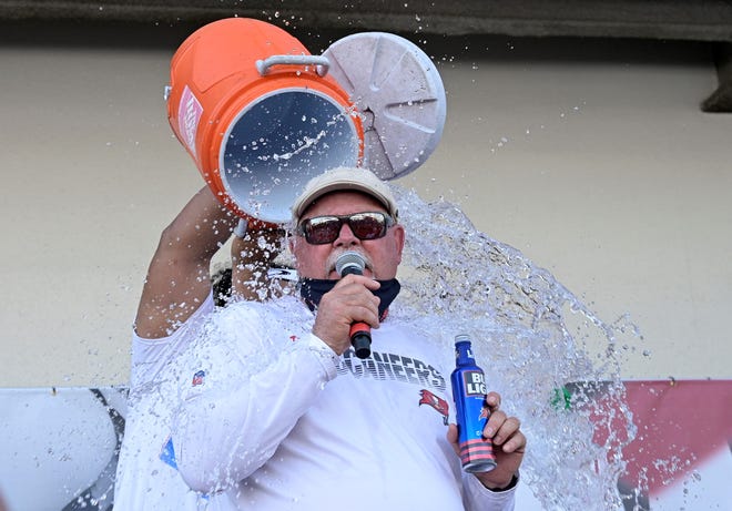 Tampa Bay Buccaneers head coach Bruce Arians is doused with a cooler by defensive lineman Vita Vea during a celebration of their Super Bowl 55 victory over the Kansas City Chiefs after taking part in a boat parade, Wednesday, Feb. 10, 2021, in Tampa, Fla. (AP Photo/Phelan M. Ebenhack)