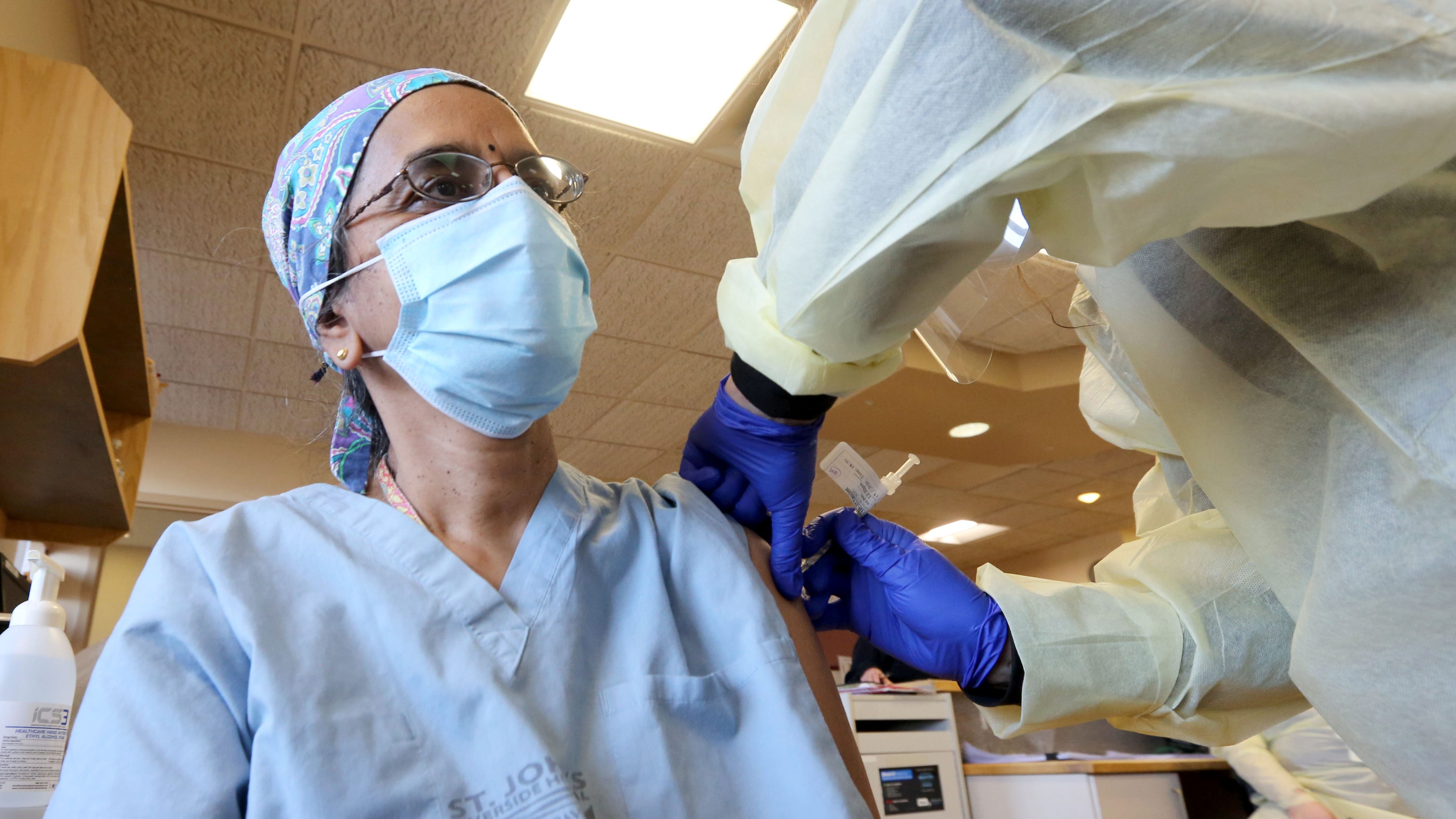 Dr. Radhika Hariharan, an infectious disease doctor at St. John's Riverside Hospital in Yonkers, N.Y. gets a COVID-19 vaccine from Linda Sugrue, R.N. Dec. 15, 2020. Dr. Hariharan was the first of forty staff members to receive the vaccine at the hospital Tuesday.