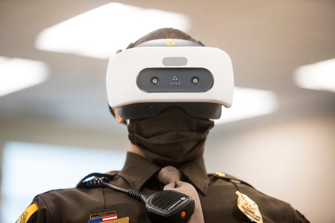 New Castle County Police Officer Ossie Cano takes a de-escalation training course using a Vive Focus Plus VR headset Monday, Feb. 8, 2021, at the New Castle County Police Headquarters. The training focuses on giving officers a choose your own adventure style simulation in dealing with subjects suffering from mental health issues. 