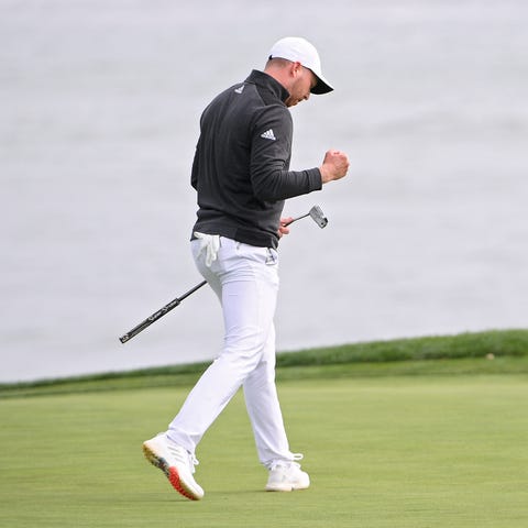 Daniel Berger reacts after making a putt for eagle
