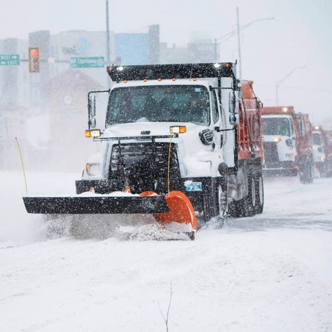 A snowplow works to clear an intersection in Oklah