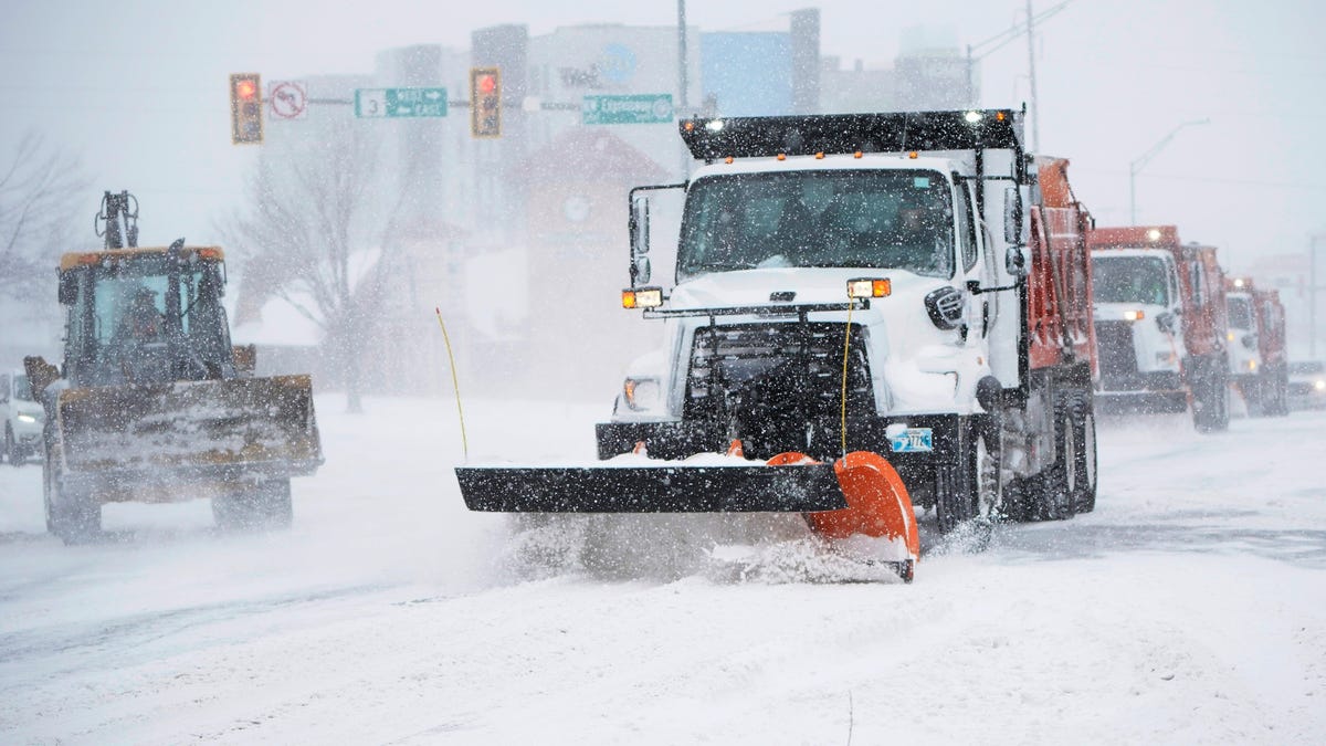 A snowplow works to clear an intersection in Oklahoma City Sunday.  Snow and ice blanketed large swaths of the U.S., prompting canceled flights, making driving perilous and reaching into areas as far south as Texas' Gulf Coast.