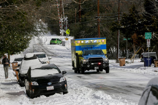 An Austin-Travis County EMS ambulance drives down Cherrywood Road in Austin on Tuesday. Since the statewide freeze, emergency crews in Austin have been flooded with medical calls, including more than 20 for carbon monoxide poisoning.