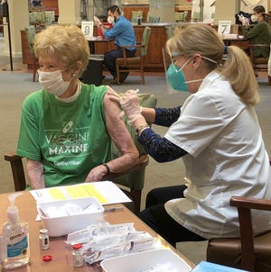 Carolina Village resident Maxine Hall receives her first dose of COVID-19 vaccine Feb. 15.
