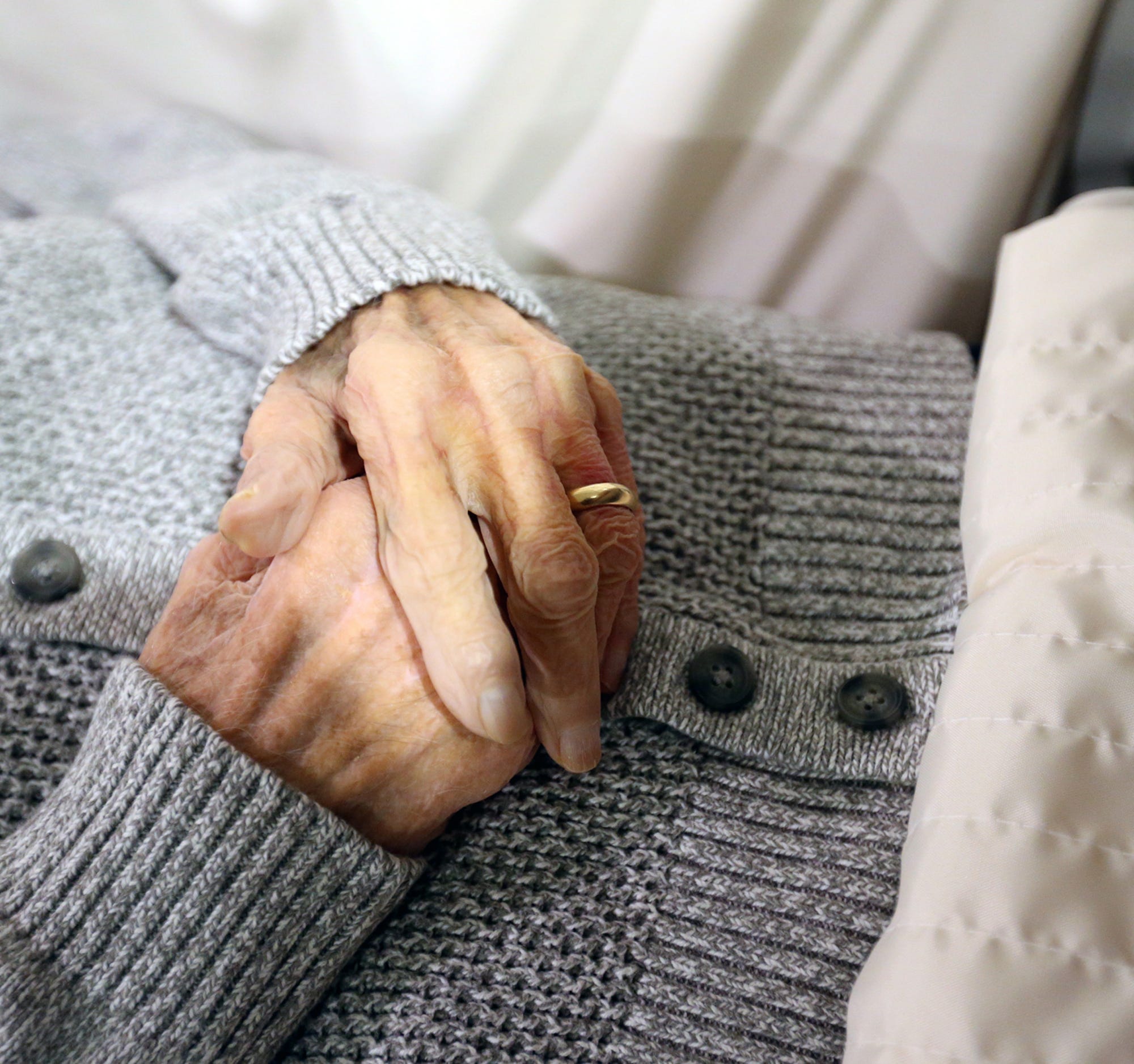 An elderly gentleman with his hands clasped rests in a casket in the chapel space at J.S. Pelkey and Son Funeral Home in Kittery, Maine.