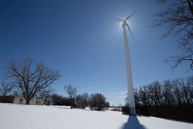 Snow covers the area surrounding a small wind turbine at the Kanza Education and Science Park near Interstate 70 and S.W. MacVicar.
