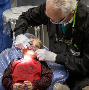 Connor Carson, 5, gives Dr. Carlton Schwartz a good look at his teeth at Gulf Coast State College on Tuesday, Feb. 16. The college's Dental Hygiene Program is hosting a Kidz Klinic in celebration of National Children's Dental Health Month. The clinic runs through Thursday.
