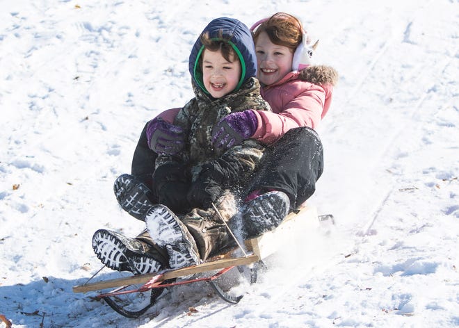 Siblings sled down a hill in Memphis, Tennessee earlier this year.