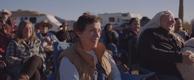 Frances McDormand in 'Nomadland' surrounded by other Nomads