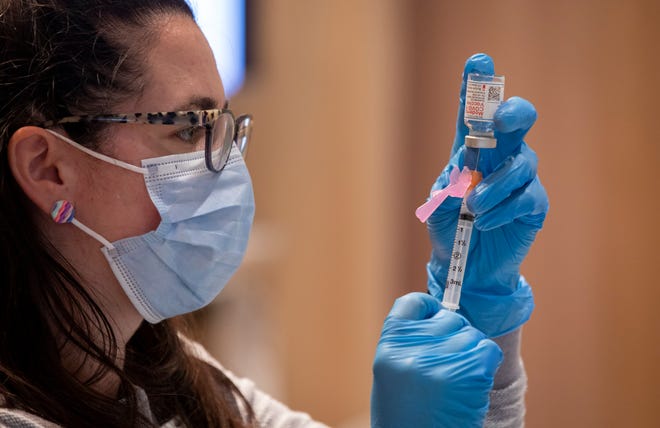 Pharmacist Jessica Tima prepares doses of the Moderna COVID-19 vaccine at Mount Carmel East hospital.