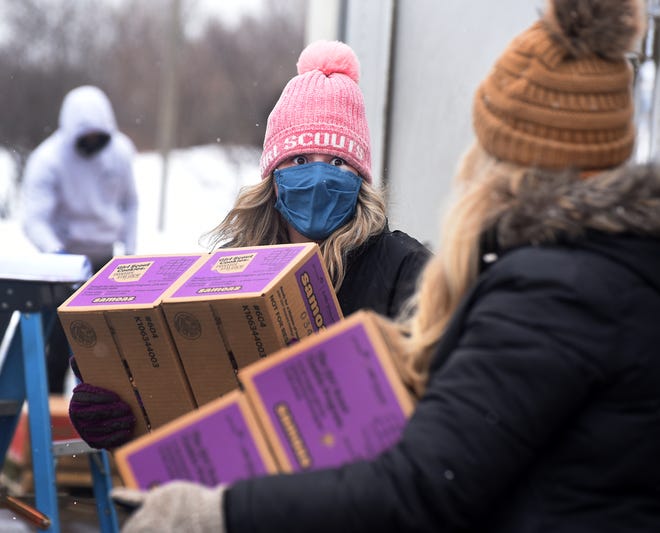In this recent photo, volunteers of Girls Scouts of Southeastern Michigan load Girl Scout cookies onto a trailer at Monroe Missionary Baptist Church. Girl Scouts of Southeast Michigan, which includes Monroe County, is expected to benefit from a large donation.