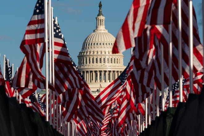 Flags are placed on the National Mall, with the U.S. Capitol behind them, ahead of the inauguration of President-elect Joe Biden and Vice President-elect Kamala Harris, Monday, Jan. 18, 2021, in Washington. (AP Photo/Alex Brandon)