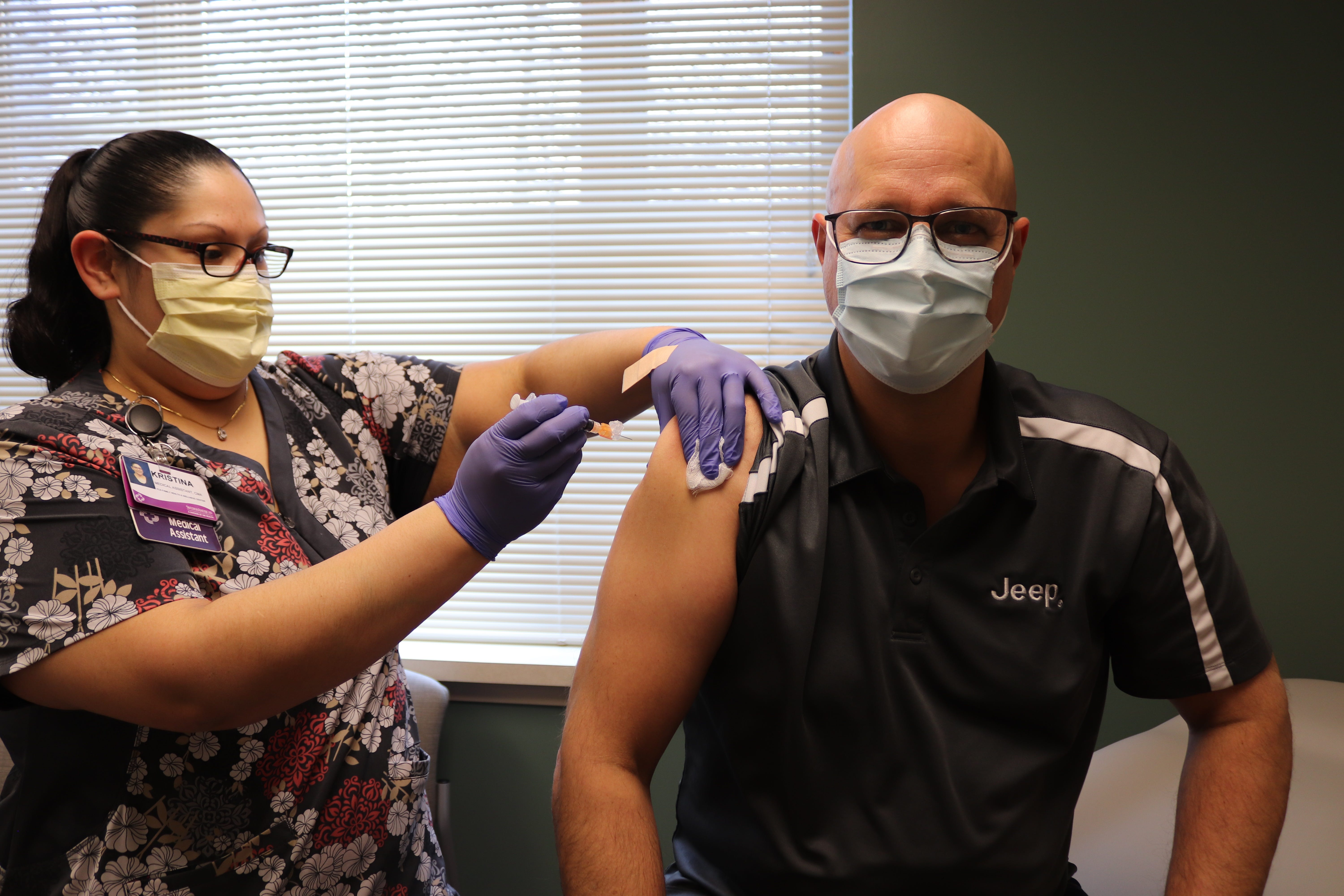 Mark Kreusel, Belvidere Assembly Plant Manager, (right) gets the COVID-19 vaccine as part of a Boone County, Illinois pilot program started on Feb. 2, 2021.