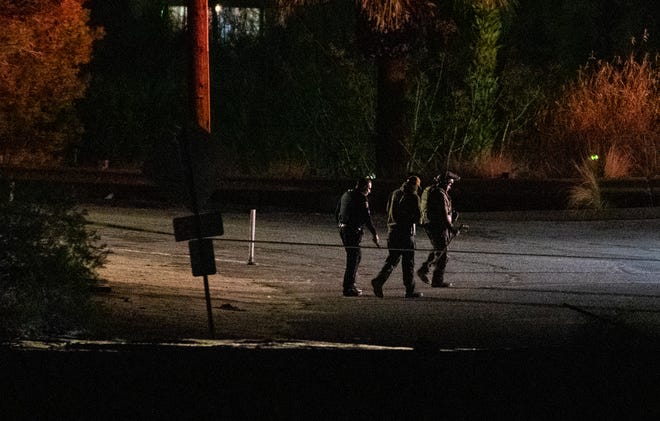 Police investigate a suspicious device near the Araby Trail in Palm Springs, Calif., February 16, 2021. 
