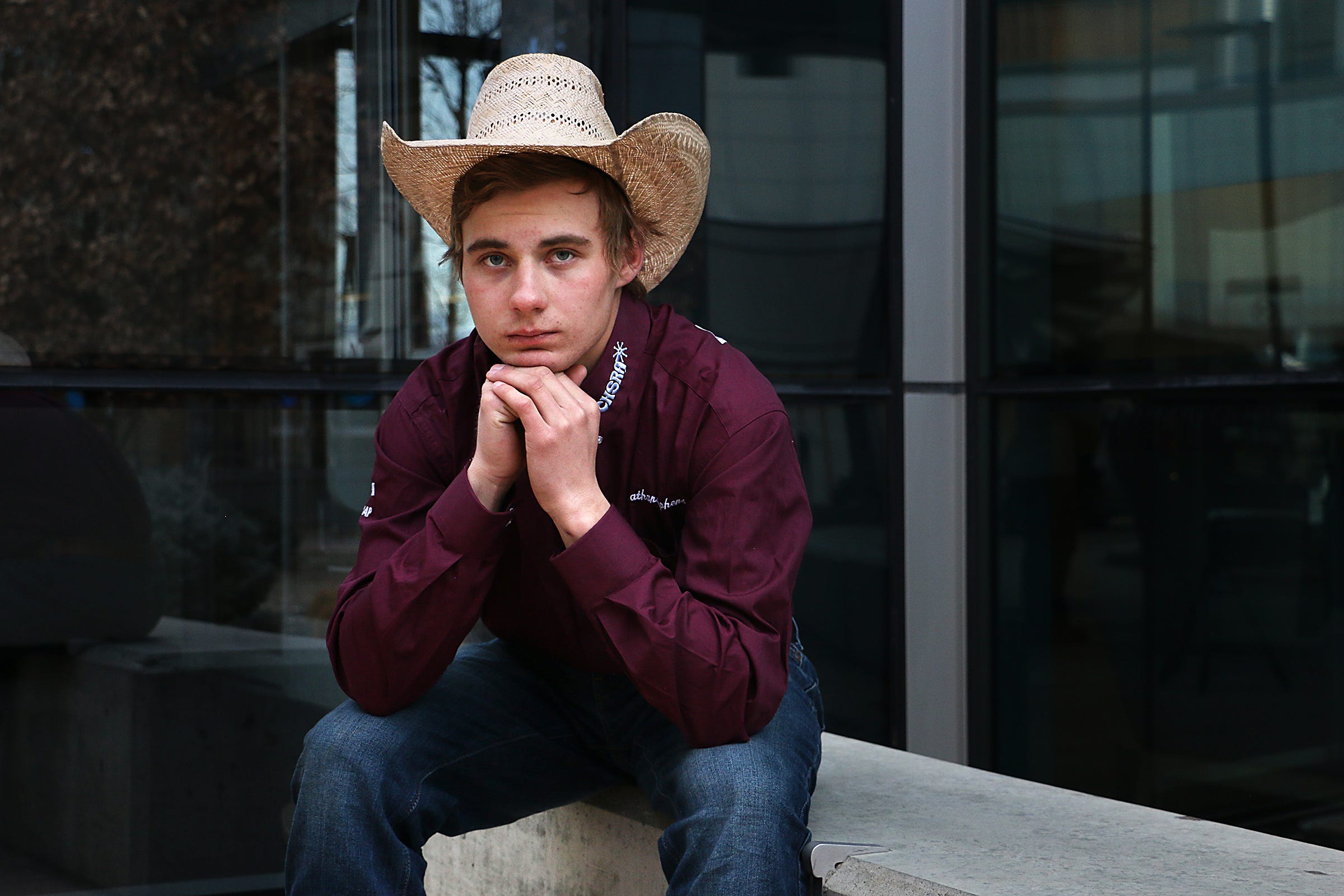Nathanial Stephens, grandson of Judy Dover, poses for a portrait while sitting outside on a bench at Renown Regional Medical Center in Reno on Feb. 13, 2021.  Stephens would sit in this exact spot while waiting and hoping to visit his grandmother in the hospital before she passed from COVID-19.