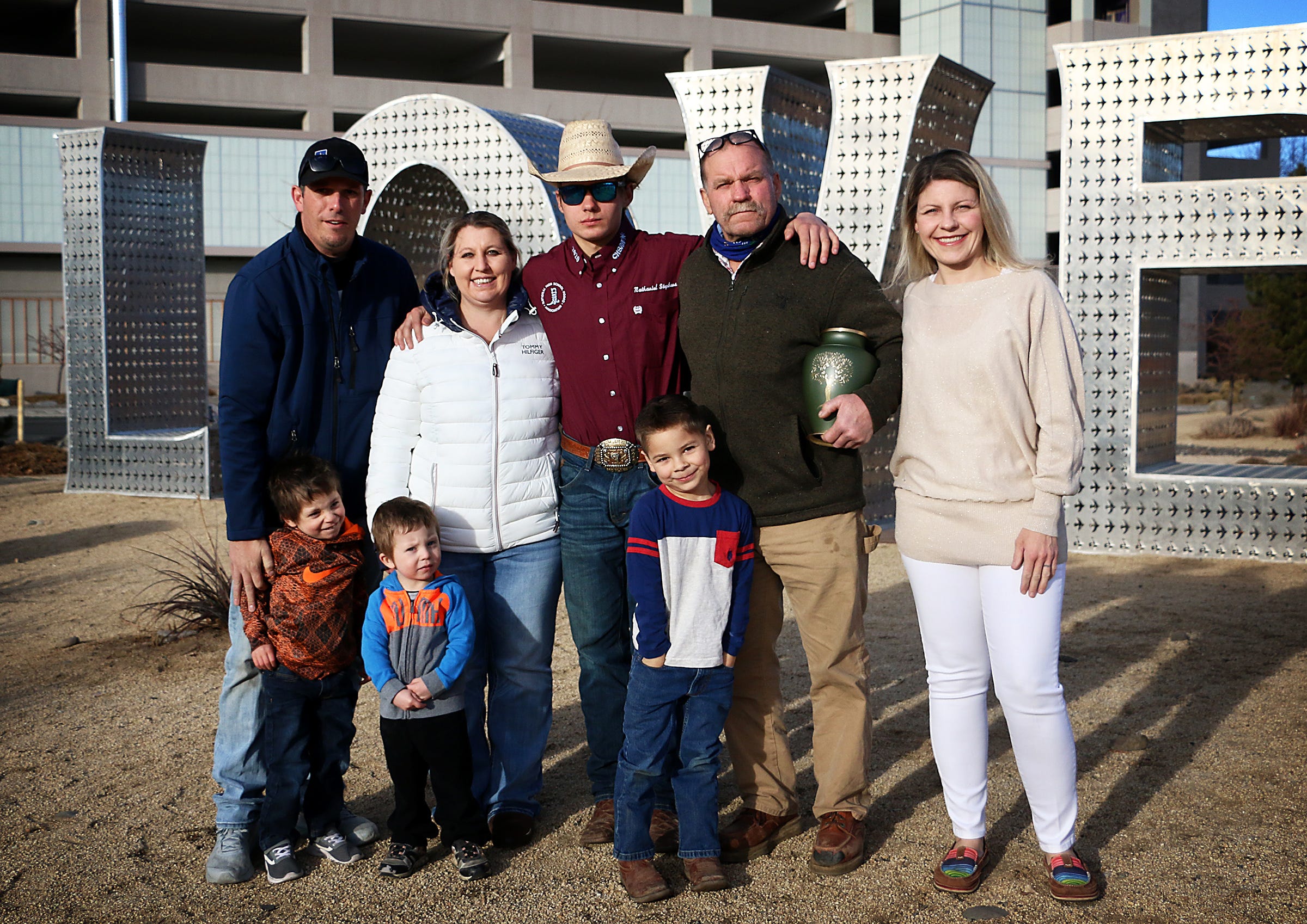 The family of Judy Dover, who died on Christmas Eve, stand with her ashes in front of the Love sculpture at Renown Regional Medical Center in Reno on Feb. 13, 2021. Back row from left: Adam Wagoner, Charity Wagoner, Nathanial Stephens, Lou Dover and Christina Barnes. Front from left: Nicolas Wagoner, Mason Wagoner and Blake Barnes.