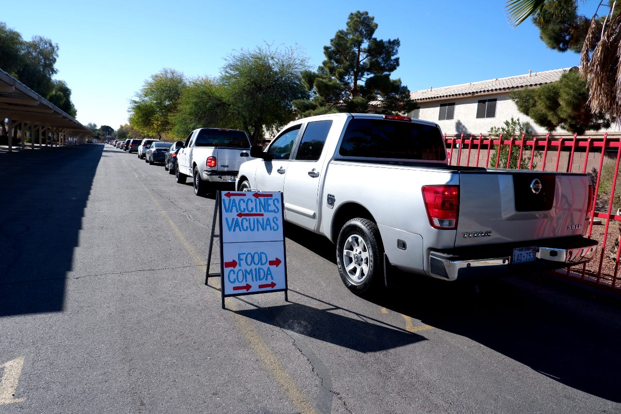 Vehicles wait in line to get food at Mater Academy in ZIP code 89110.