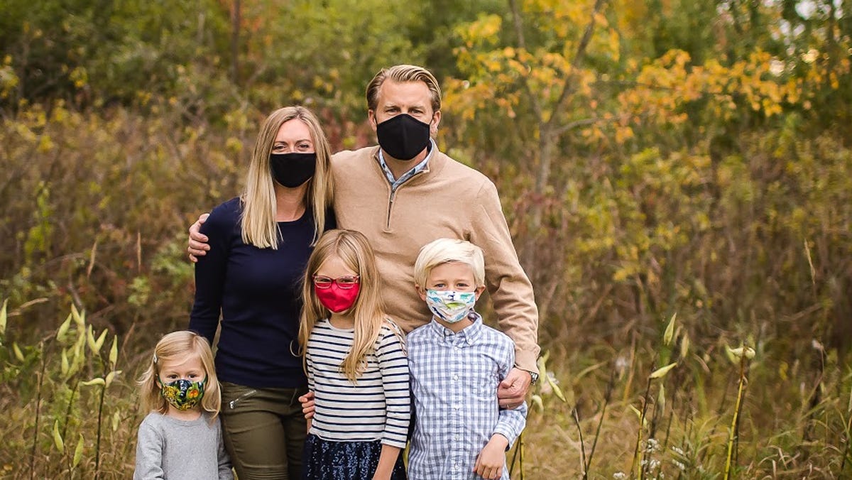 Abby Adair Reinhard, her husband Josh, and their three kids pose for a family photo in summer 2020.