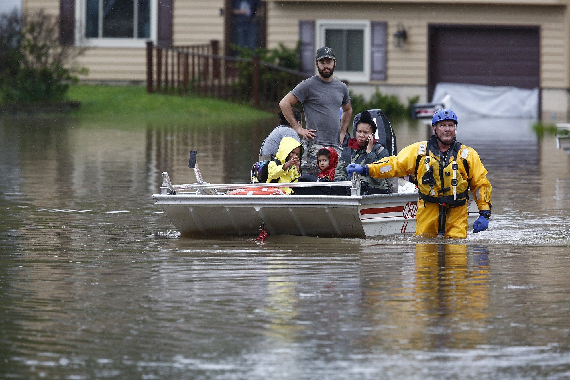 The Columbus Fire Department uses a boat to evacuate people from their homes on Stoneshead Ct. on Tuesday, May 19, 2020 after heavy rains pounded the area overnight.