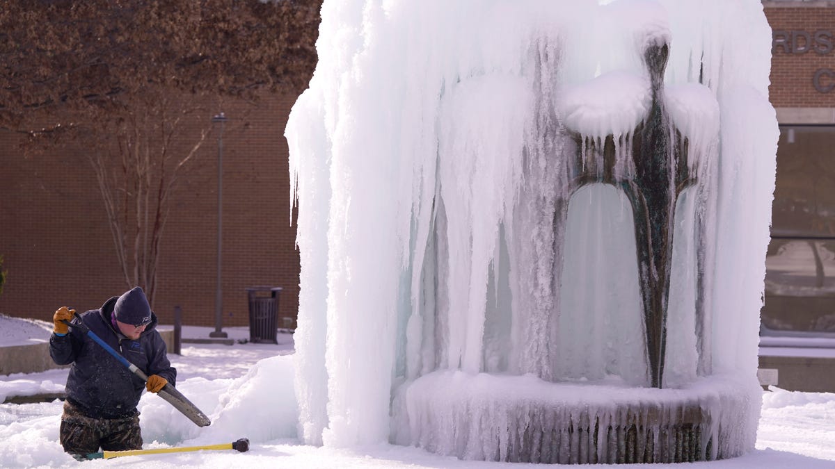 City of Richardson worker Kaleb Love works to clear ice from a water fountain Tuesday, Feb. 16, in Richardson, Texas.