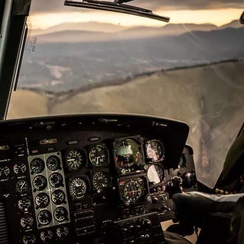 Flying in sunset over mountains in cockpit