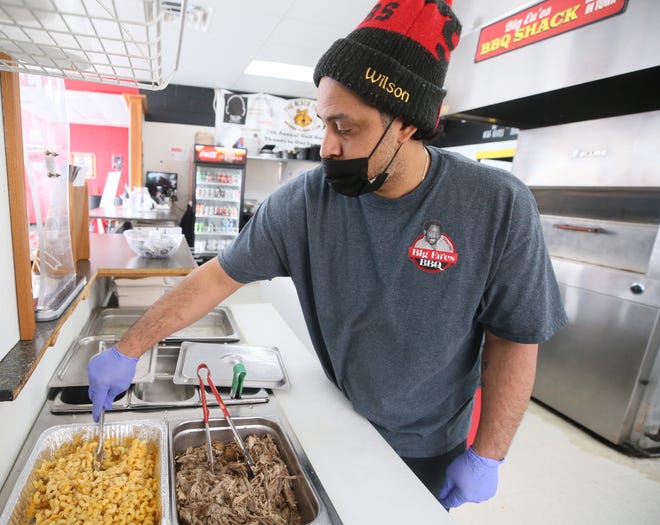 Eugene Wilson Jr., owner of Big Eu'es BBQ in Cuyahoga Falls, stirs a pan of macaroni and cheese.