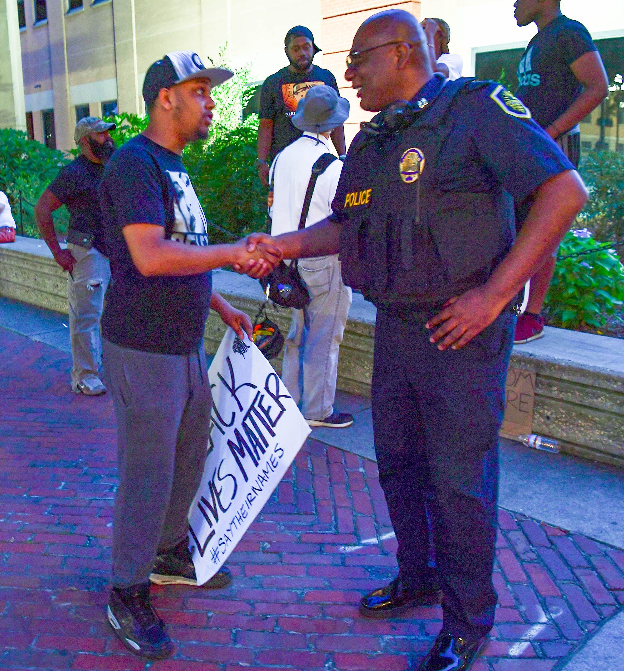 Jamel Hunter of Anderson shakes hands with Capt. Mike Aikens during a protest remembering George Floyd in downtown Anderson, S.C., on June 3, 2020.