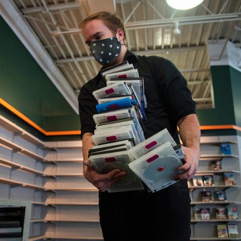 Family Video manager Cameron Redshaw gathers DVDs 