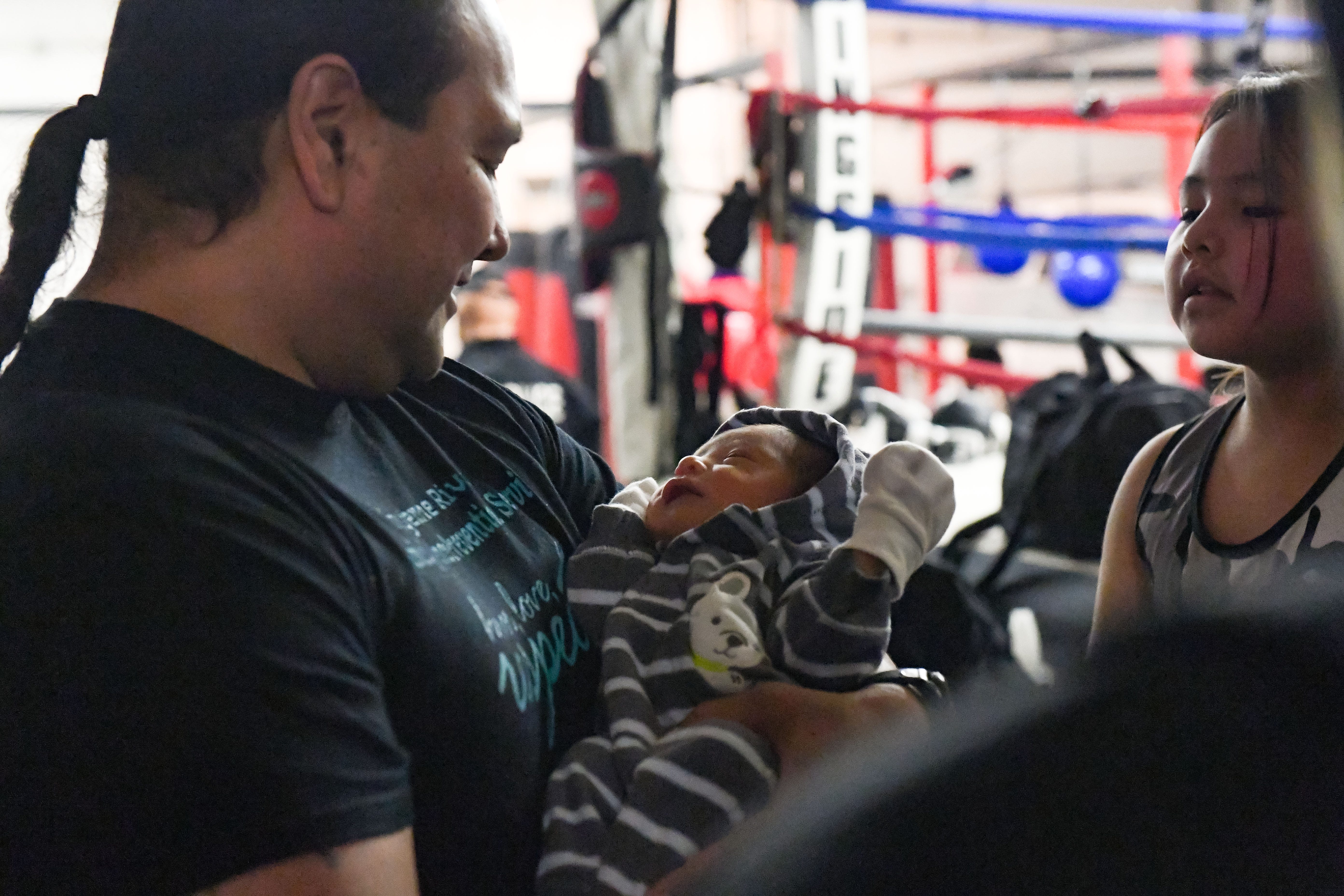 Joe Brings Plenty holds his week-old grandson, Hasyne, on Feb. 17 in Eagle Butte, South Dakota. Hasyne's parents, Joseph Brings Plenty Jr. and Kelsey LeBeau, are also law enforcement officers.