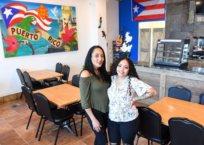Johanna de Jesus and her daughter, Harianys de Jesus, stand in the dining area of their new Puerto Rican restaurant on Thursday, Feb. 18, at La India Taina in Sioux Falls.