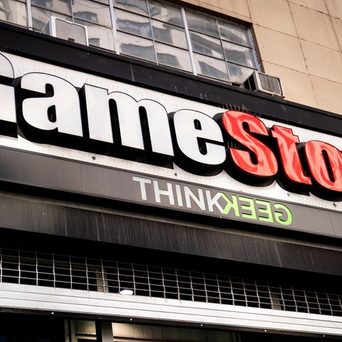FILE - Pedestrians pass a GameStop store on 14th S