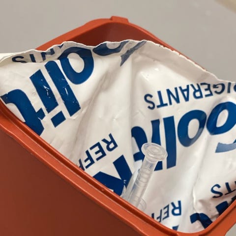 A syringe filled with COVID-19 vaccine in a transp