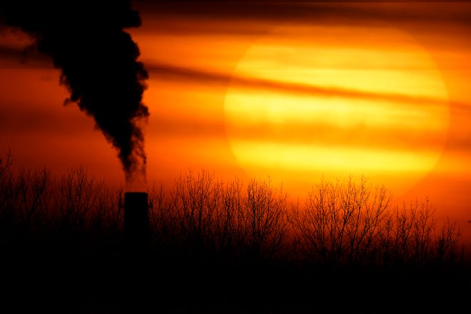 FILE - In this Monday, Feb. 1, 2021 file photo, emissions from a coal-fired power plant are silhouetted against the setting sun in Independence, Mo. A United Nations report released on Thursday, Feb. 18, 2021 says humans are making Earth a broken and increasingly unlivable planet through climate change, biodiversity loss and pollution. So the world must make dramatic changes to society, economics and daily life. (AP Photo/Charlie Riedel)