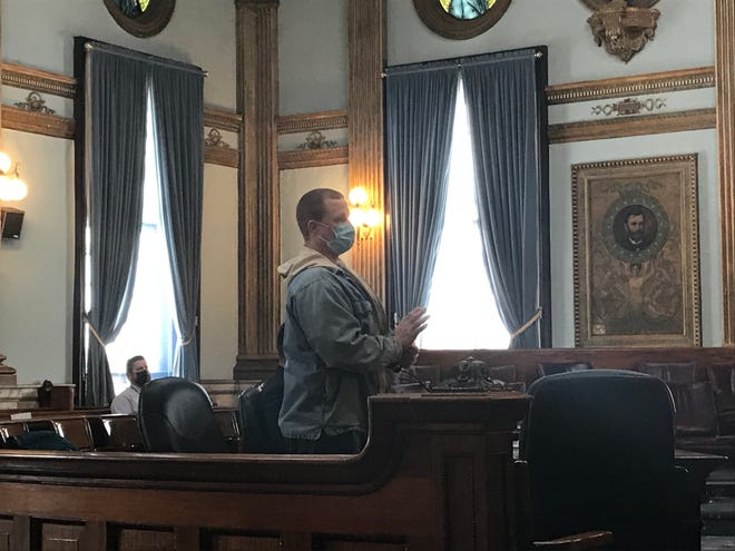 Roy Ramsey II (center) stands and raises his hand to be placed under oath for a change of plea and sentencing hearing in Licking County Common Pleas Court on Friday, Feb. 19, 2021. Ramsey pleaded guilty to a charge of voluntary manslaughter and was sentenced to 8-12 years in prison.