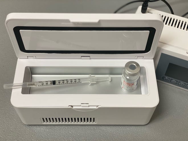 A syringe filled with COVID-19 vaccine in a battery-powered refrigerated transportation container. In Seminole County, Florida, county staff use these to take any extra doses of vaccine to home-bound seniors or nearby nursing homes after vaccine clinics.