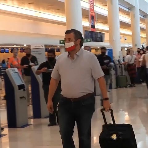 Sen. Ted Cruz, R-Texas, checks in for his flight b