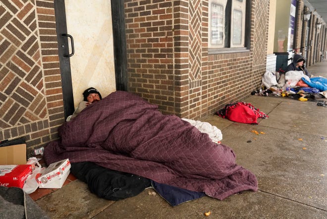 People living on the streets use blankets to keep warm, Thursday, Feb. 18, 2021, in downtown San Antonio. Snow, ice and sub-freezing weather continue to wreak havoc on the state's power grid and utilities. 